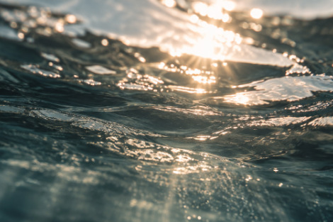 Sunlight moving across dark water